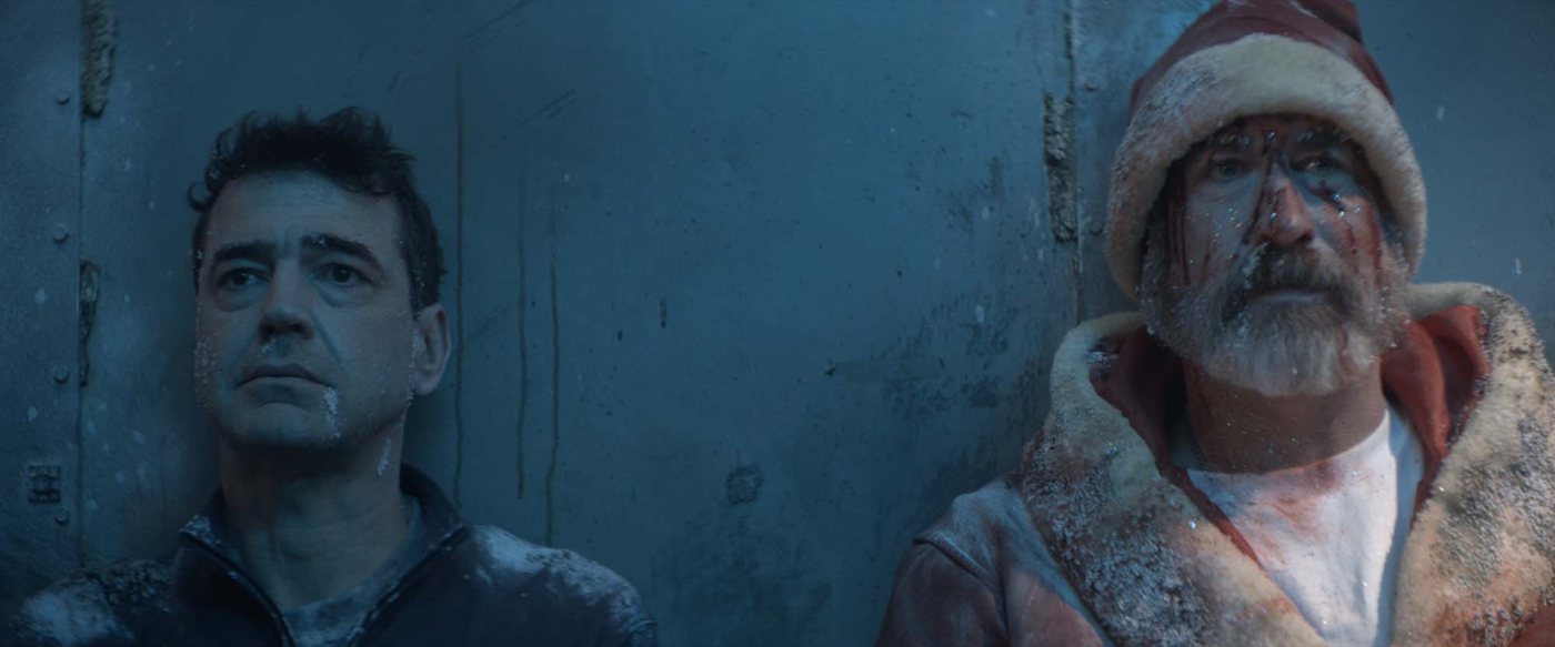 Mark beside a bloodied, frost-covered Santa